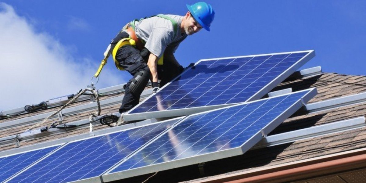 Man on a roof with solar panels